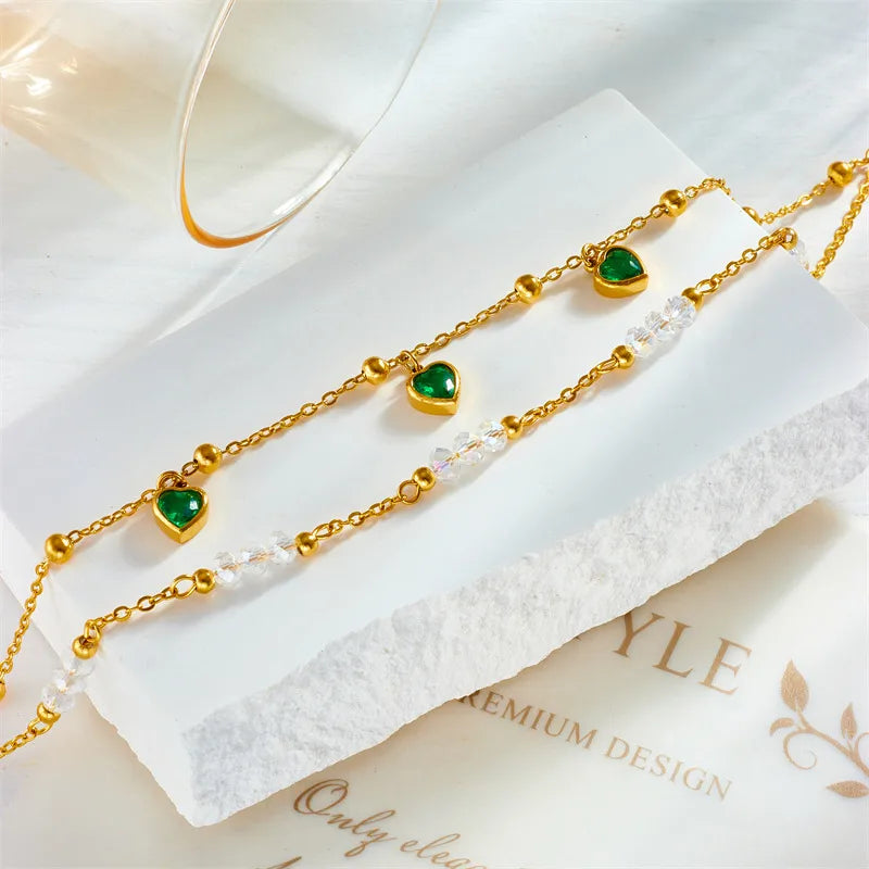 "Collection of delicate anklets in silver and gold with various charms"