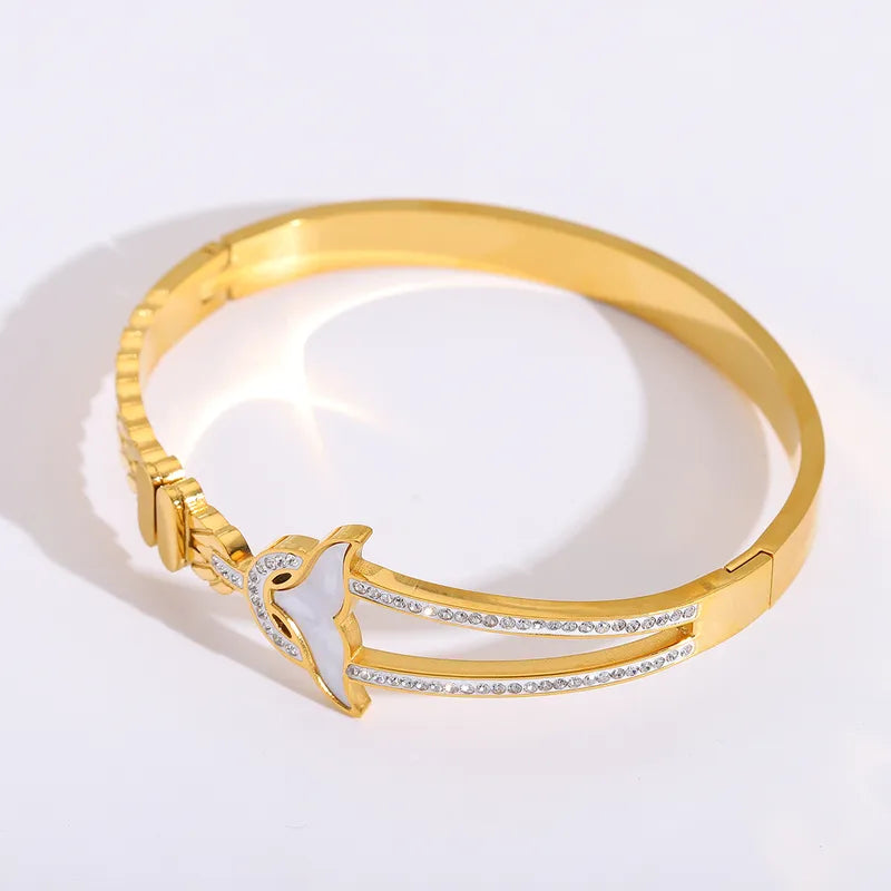 Gold bracelet with a unique design on a white background