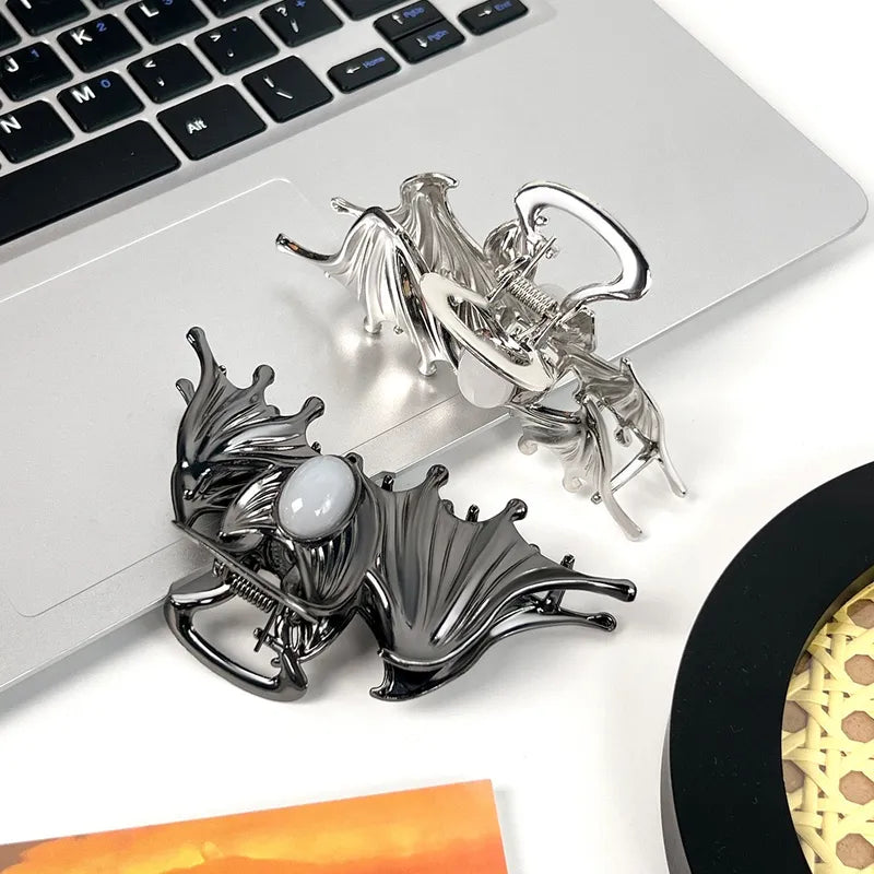 Decorative metal dragon figurines on a laptop keyboard