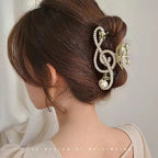 Hair bun with decorative hair clip featuring a music note design.