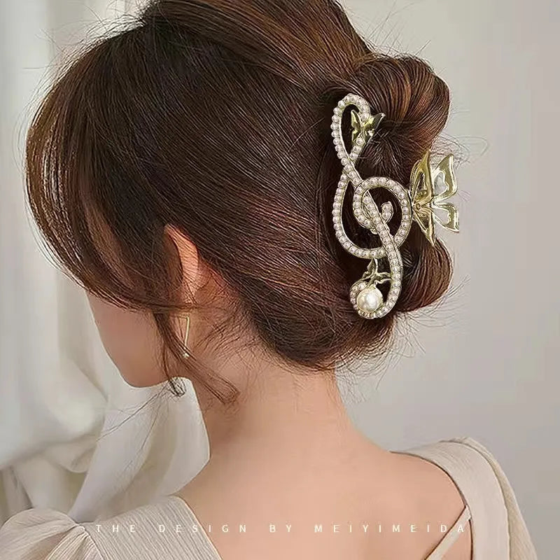 Hair bun with decorative hair clip featuring a music note design.