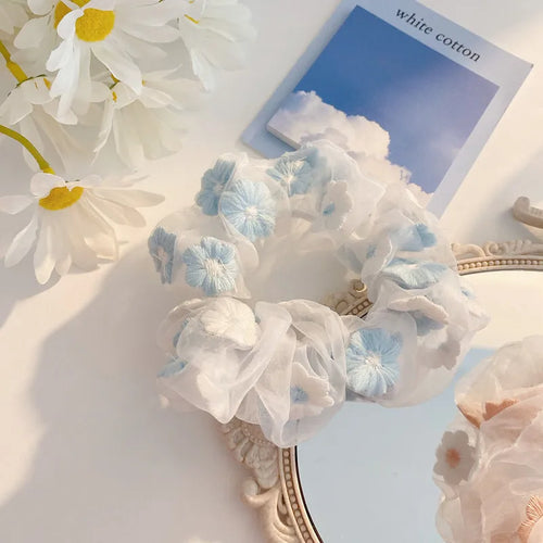 Floral headband with white and blue flowers on a mirror background