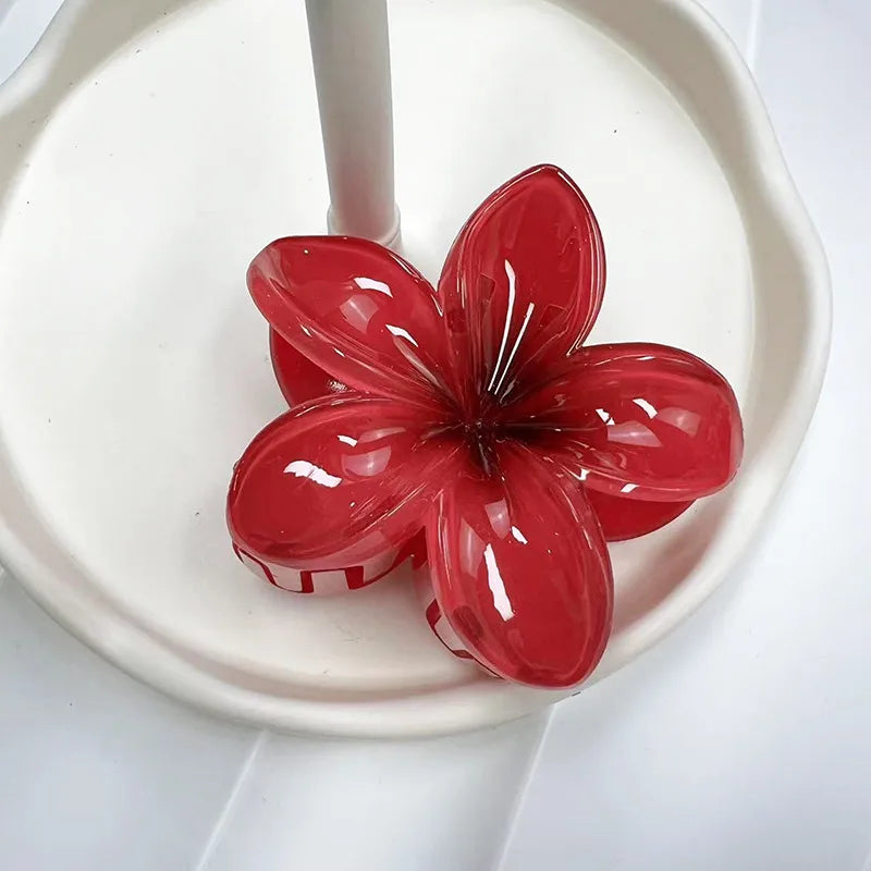 Red flower-shaped clip on a white plate