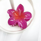 Pink flower-shaped clip on a white plate