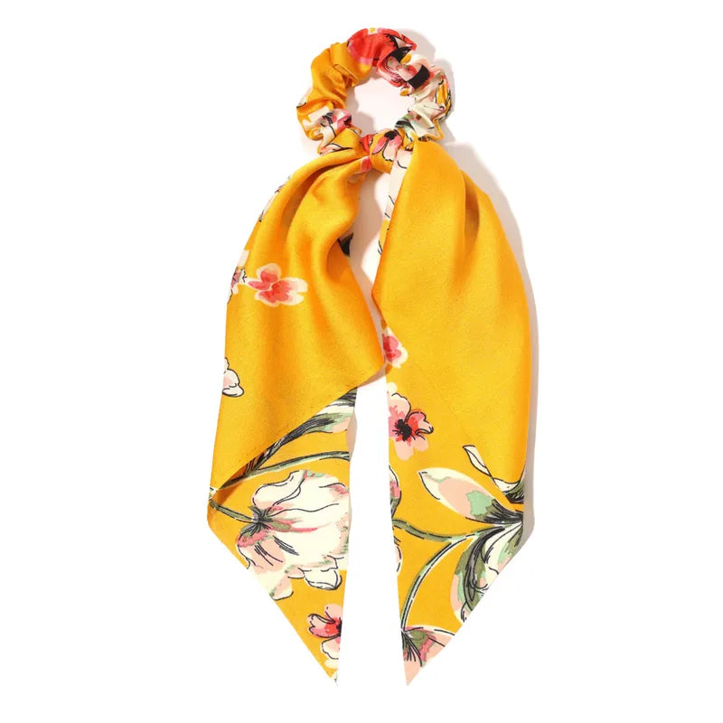 Yellow floral scrunchie on a white background