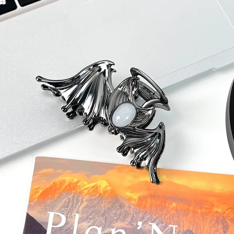Decorative clip with a central gemstone on a white surface
