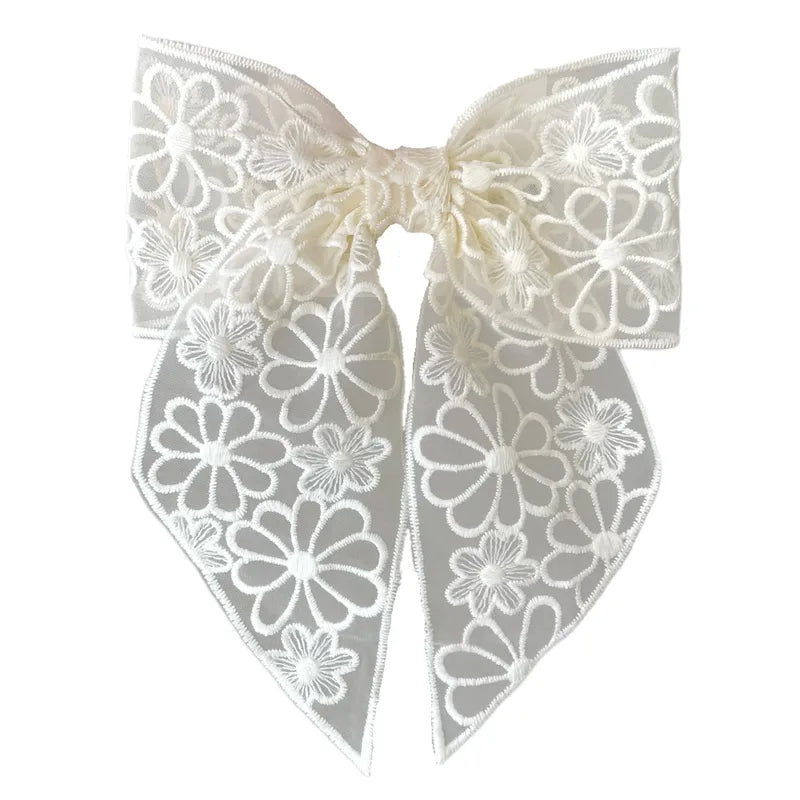 White lace bow with floral patterns on a white background